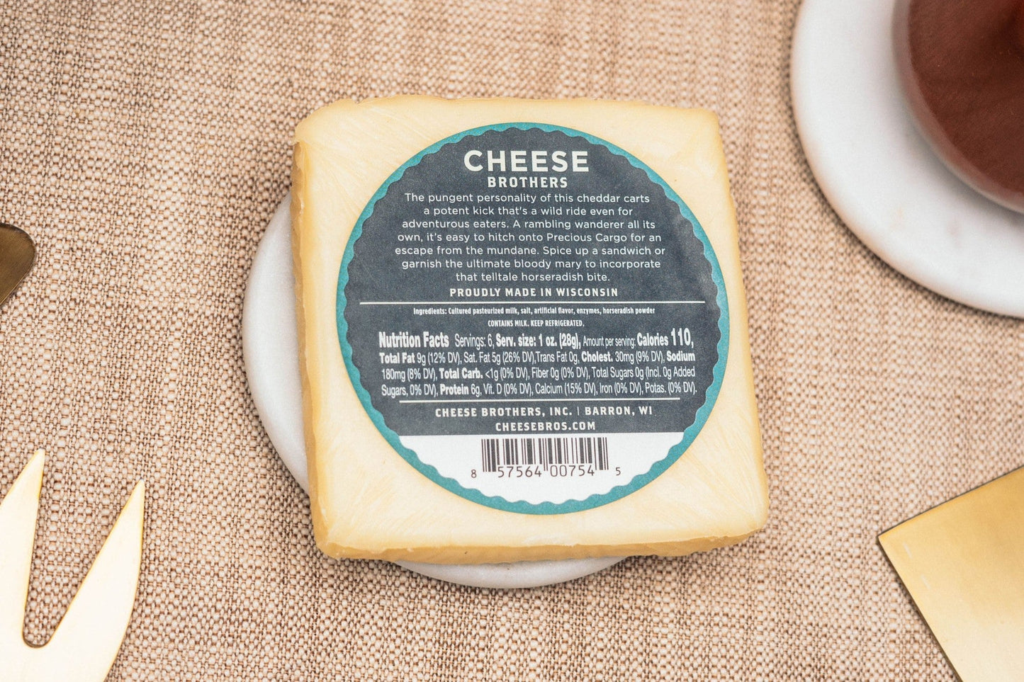 Slices of Precious Cargo Horseradish Cheddar cheese from Cheese Brothers, Inc. showing its rich, sharp cheddar with horseradish infusion.