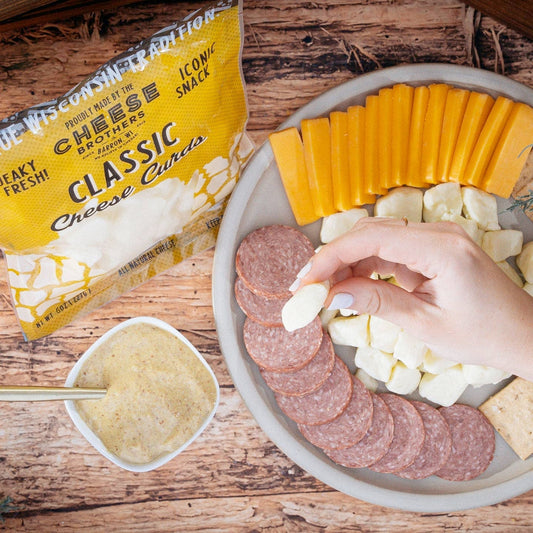 Wisconsin Cheese Brothers Inc. cheese curds in a pack, showcasing fresh, golden cheese curds ready to enjoy.