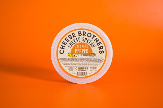 Creamy jalapeño pepper cheese spread by Cheese Brothers, Inc. in a smooth, flavorful cheese spread container.