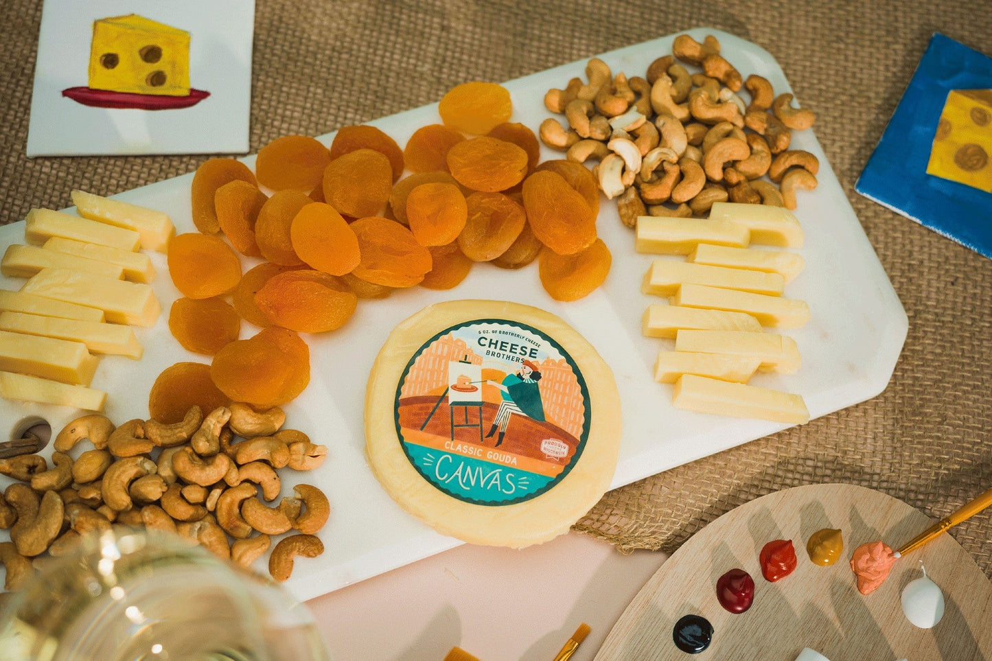 Creamy Classic Gouda cheese from Cheese Brothers, Inc., showing a smooth, yellow block of Gouda on a wooden surface.