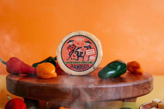 Smoked 3 Amigos Spicy Gouda cheese by Cheese Brothers, Inc. with a rich, smoky appearance and a hint of spice.
