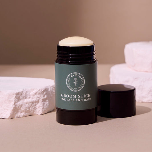 Clara & Fritz Tallow Shop Groom Stick, natural grooming product for skin and coat care, with a sleek design and key branding visible.