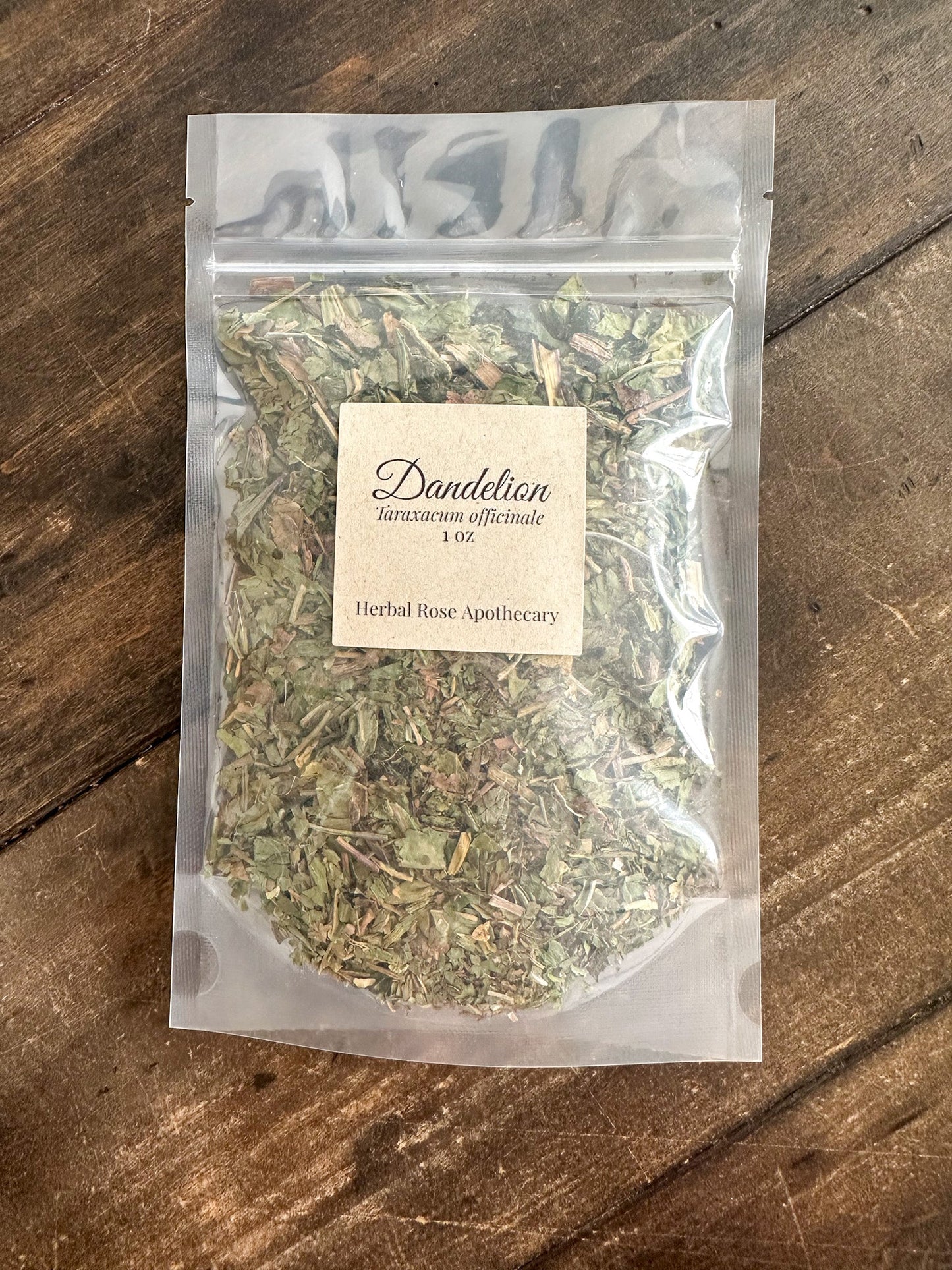 Dried dandelion herbs in a 1oz package from Herbal Rose Apothecary, showcasing fresh, vibrant yellow leaves and flowers.
