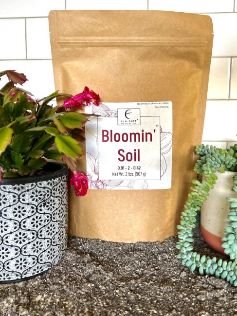 Elm Dirt Bloomin' Soil Organic Flower Booster bag showing 2 lbs of soil for promoting bigger, longer-lasting blooms in garden flowers.