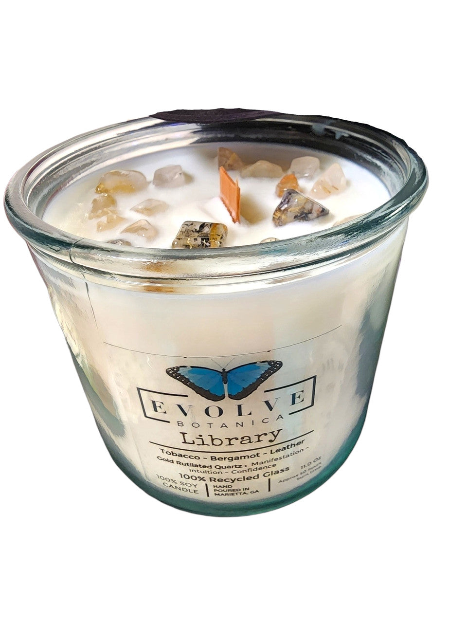 Evolve Botanica Rocks Candle Library soy candle with wood wick, gold rutilated quartz gemstone, and decorative packaging.