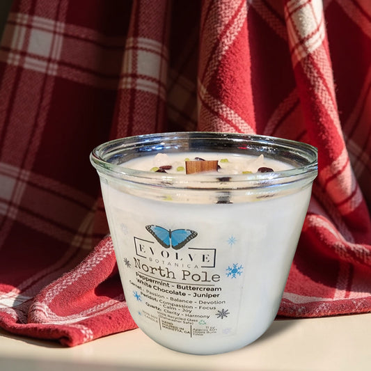 Evolve Botanica North Pole Rocks Candle with wood wick, garnet, peridot, and quartz stones for passion, compassion, and harmony.