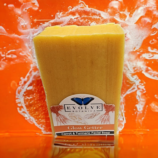 Evolve Botanica Glow Getter facial soap with carrot, turmeric, and honey, showcasing the natural soap bar with vibrant ingredients.