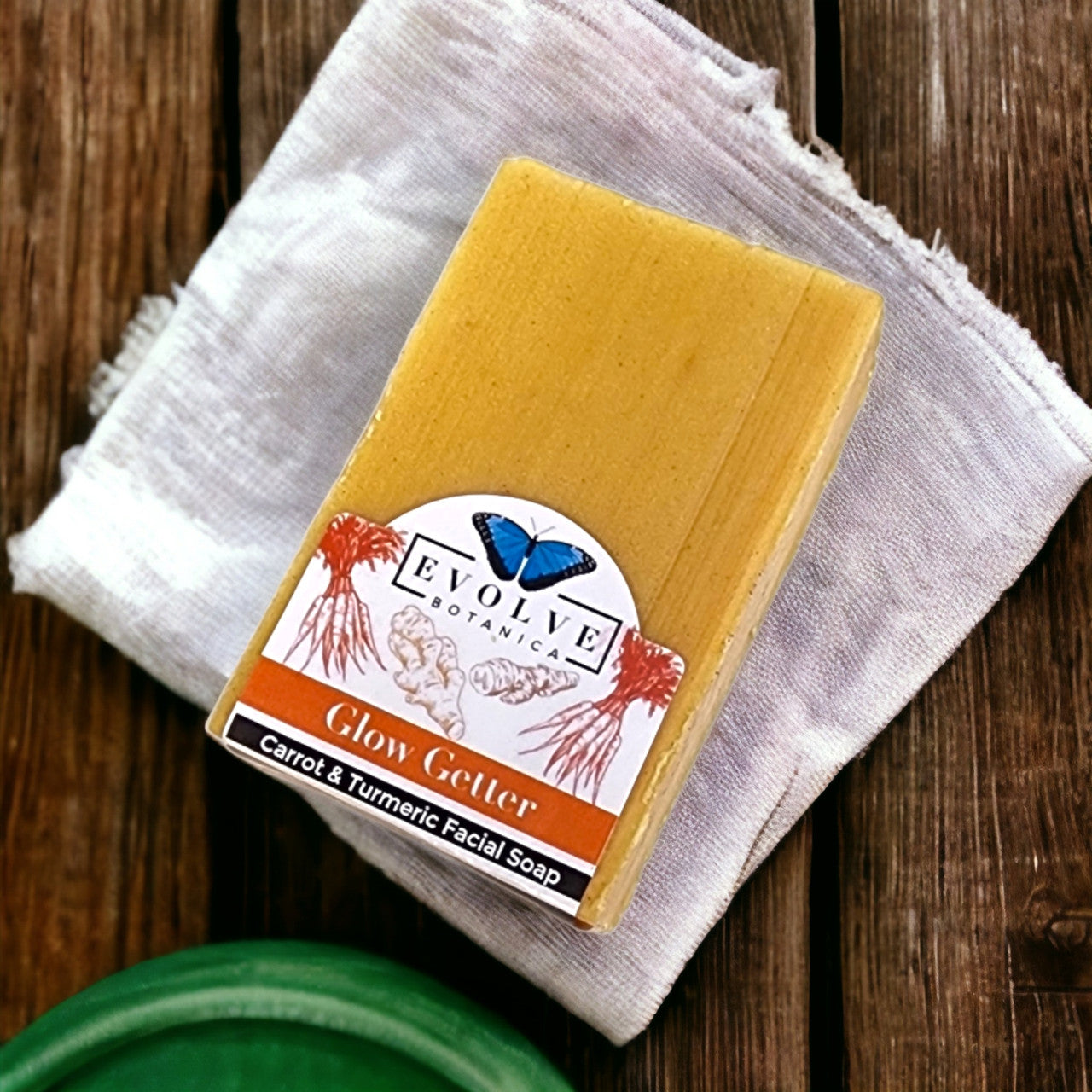 Evolve Botanica Glow Getter facial soap with carrot, turmeric, and honey for brightening and nourishing skin.