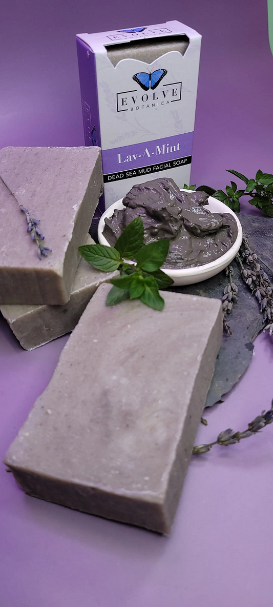 Evolve Botanica Lav-A-Mint Dead Sea Mud Facial Soap in a clear glassine bag, showcasing the natural soap with mint and mud ingredients.
