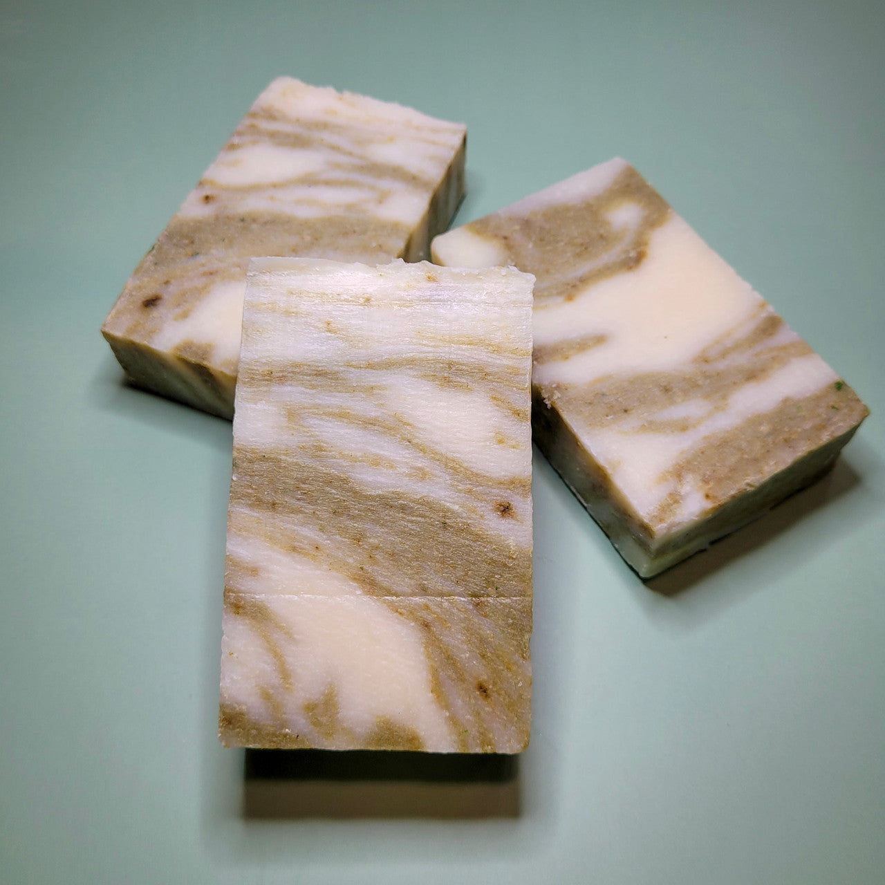Evolve Botanica peppermint rosemary standard soap bar wrapped in unprinted glassine bag for shipping.