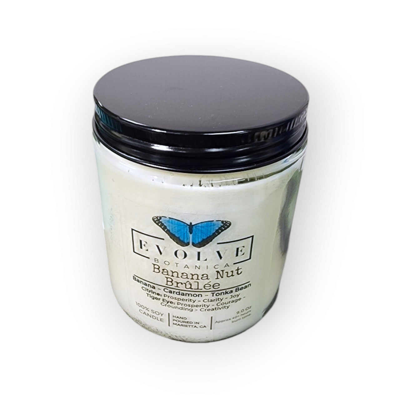 Evolve Botanica 9oz Jam Jar Crystal Soy Candle with Banana Nut Brulee scent, featuring Citrine and Tiger's Eye stones, natural wood wick