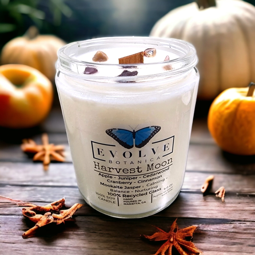 Evolve Botanica 9oz jam jar crystal soy candle with harvest moon scent and mookite gemstone, natural wood wick for cozy ambiance.