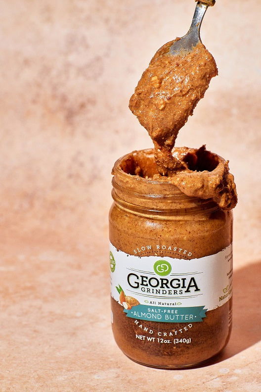 Two 12oz jars of Georgia Grinders almond butter, including original and salt-free varieties, in the almond butter gift pack.