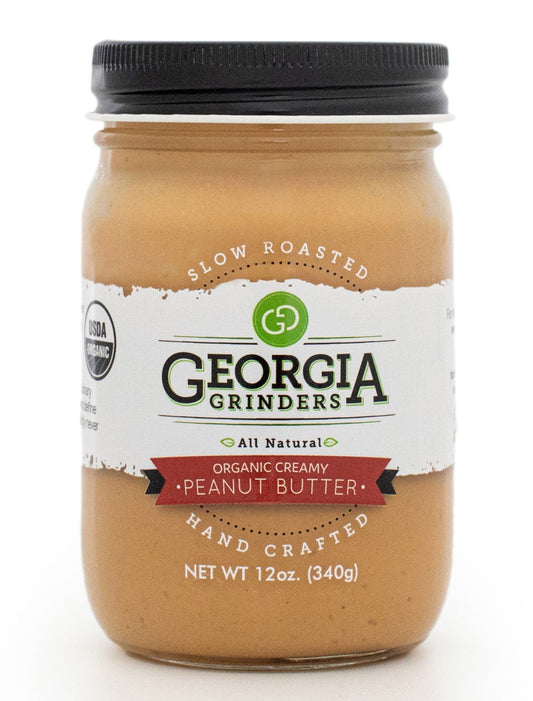 Organic creamy peanut butter in a 64oz bulk tub by Georgia Grinders, showing smooth texture and white lid.