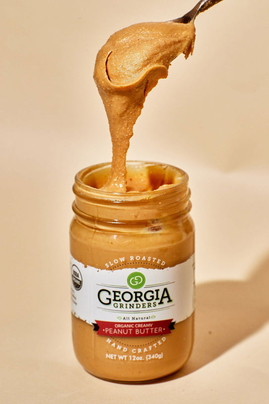 Georgia Grinders Organic Creamy Peanut Butter 4-pack, 12 oz jars, smooth nut butter in a clear view of the four jars.