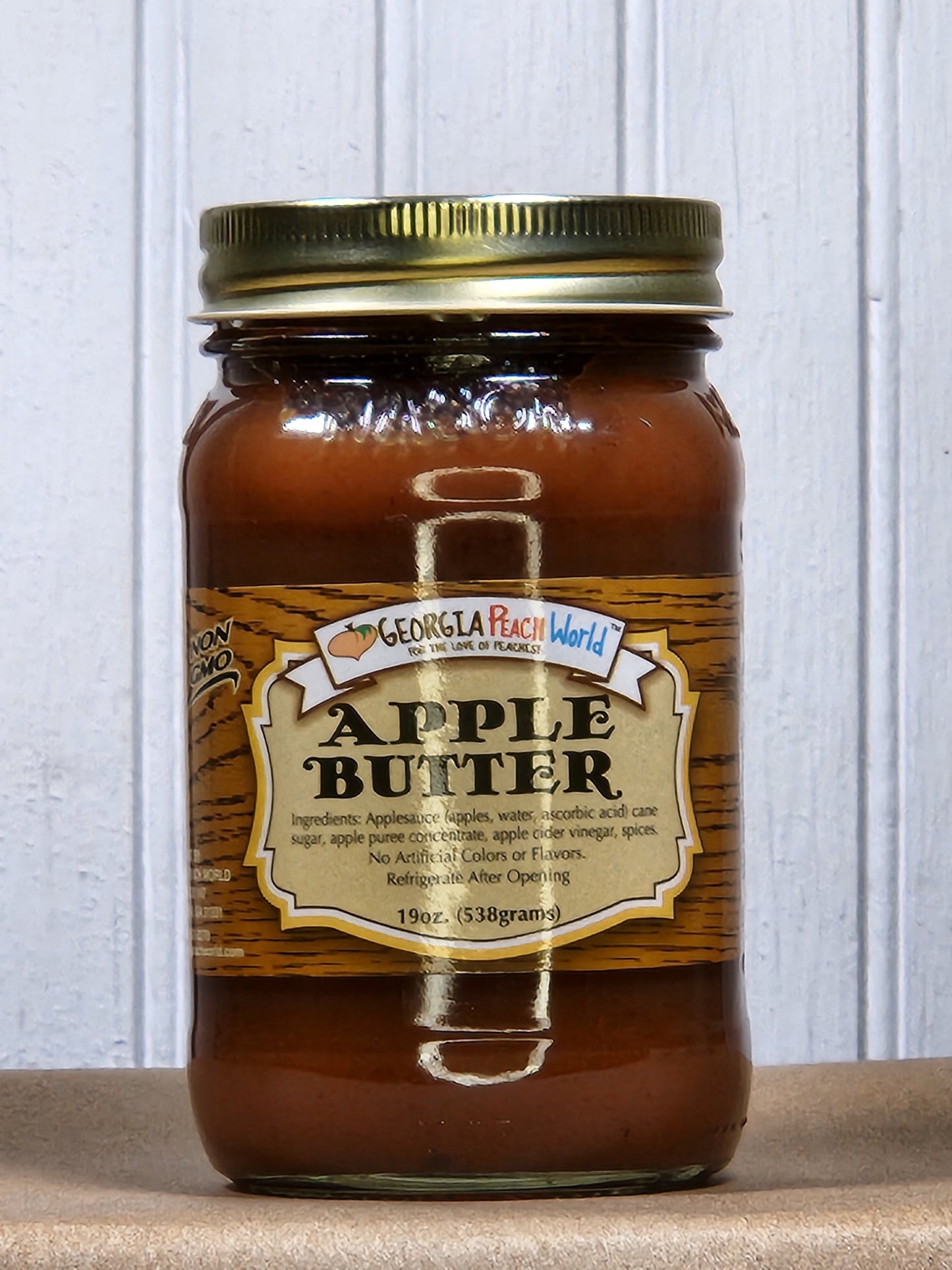 Creamy apple butter from Georgia Peach World in a jar, perfect for spreading on toast or using in recipes.