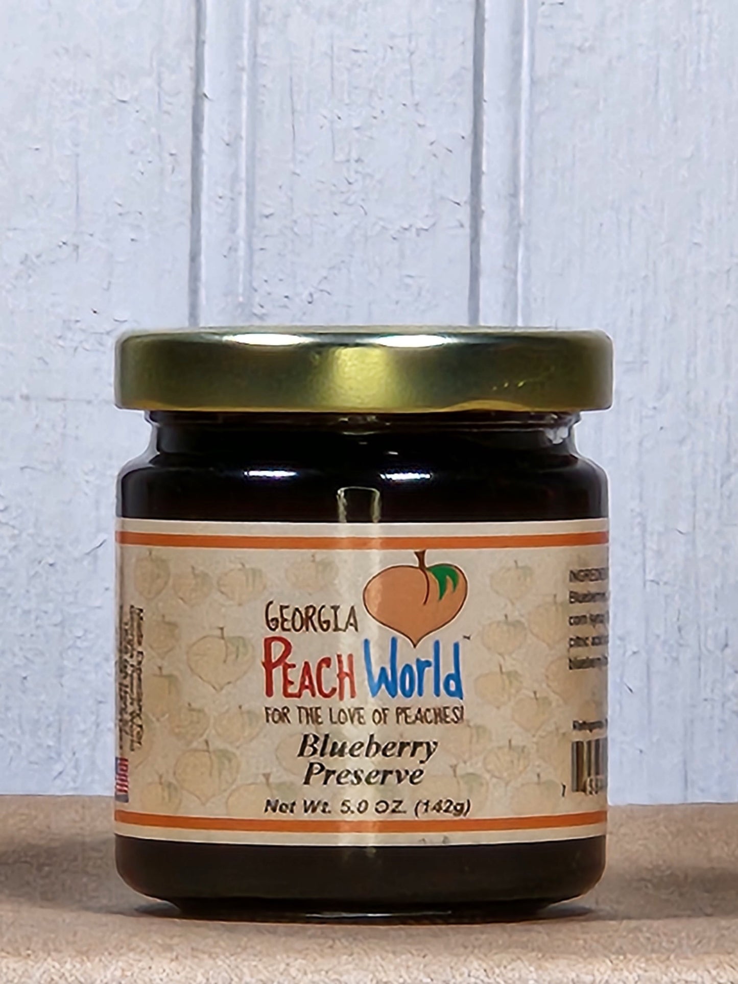 5oz jar of Georgia Peach World blueberry preserve, a rich and fruity spread in a glass jar, ideal for breakfast or snacks.
