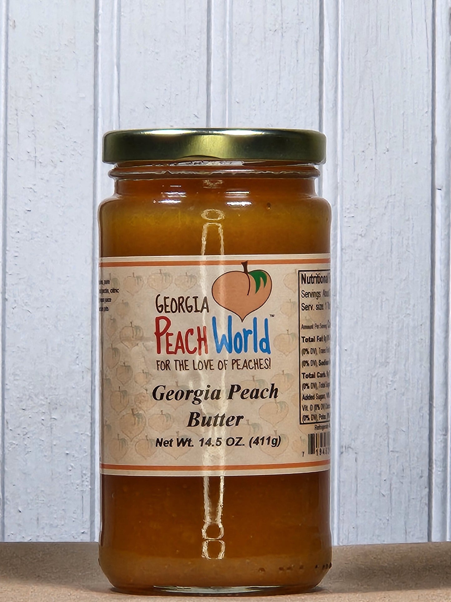 Georgia Peach World peach butter spread in a 14.5 oz jar, creamy and smooth with fresh peach flavor, ideal for breakfast or snacks.