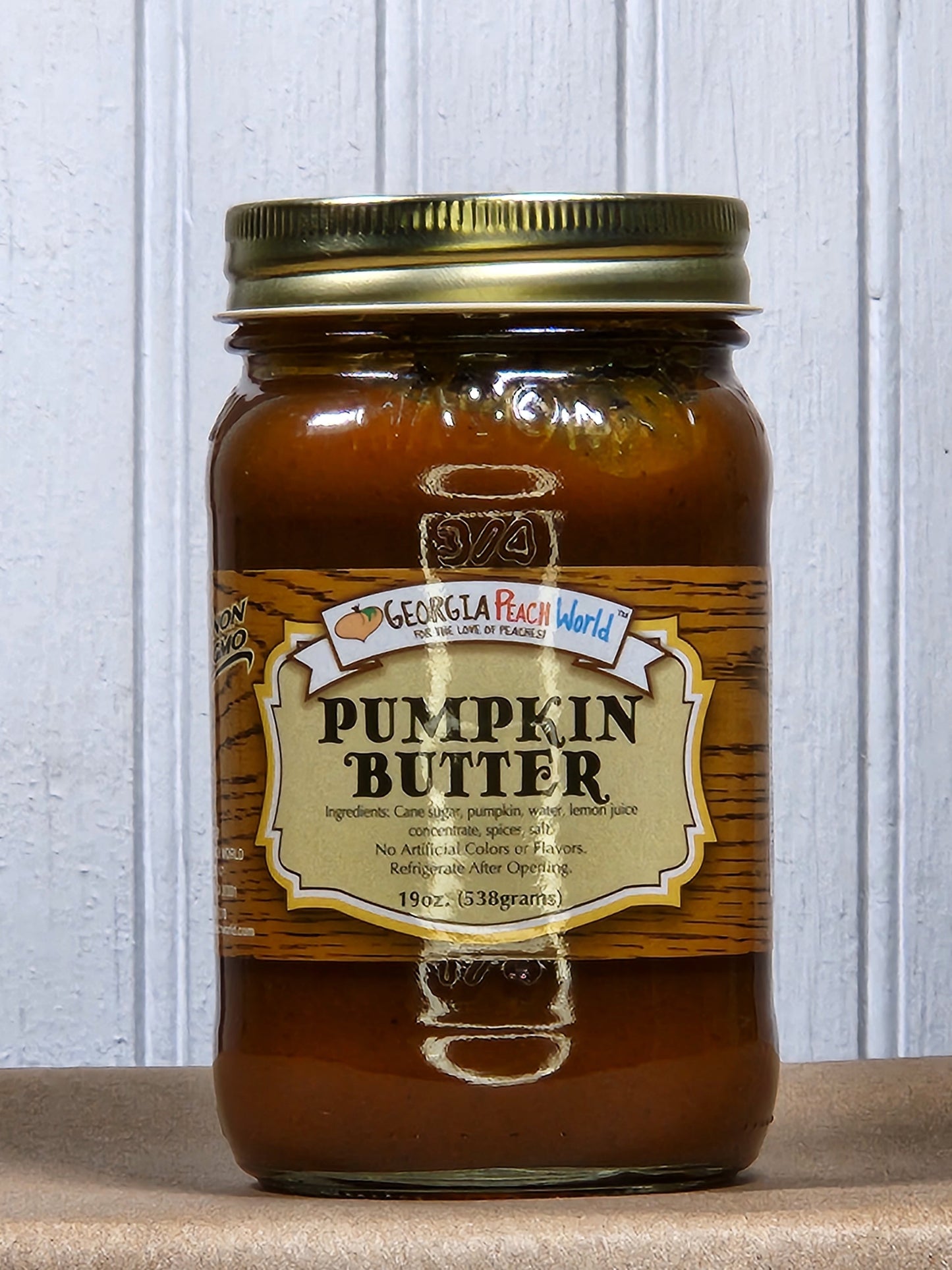 Creamy pumpkin butter from Georgia Peach World, spread in a jar with a rustic label, perfect for toast or baking.
