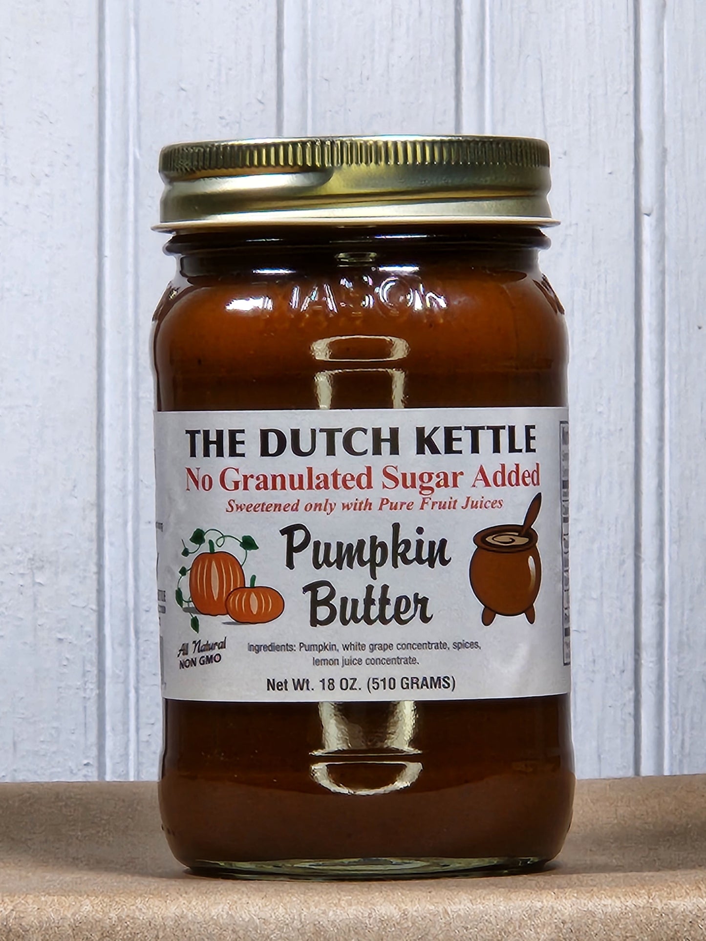 Creamy pumpkin butter spread from Georgia Peach World, no sugar added, in a jar with pumpkin and spread texture visible.