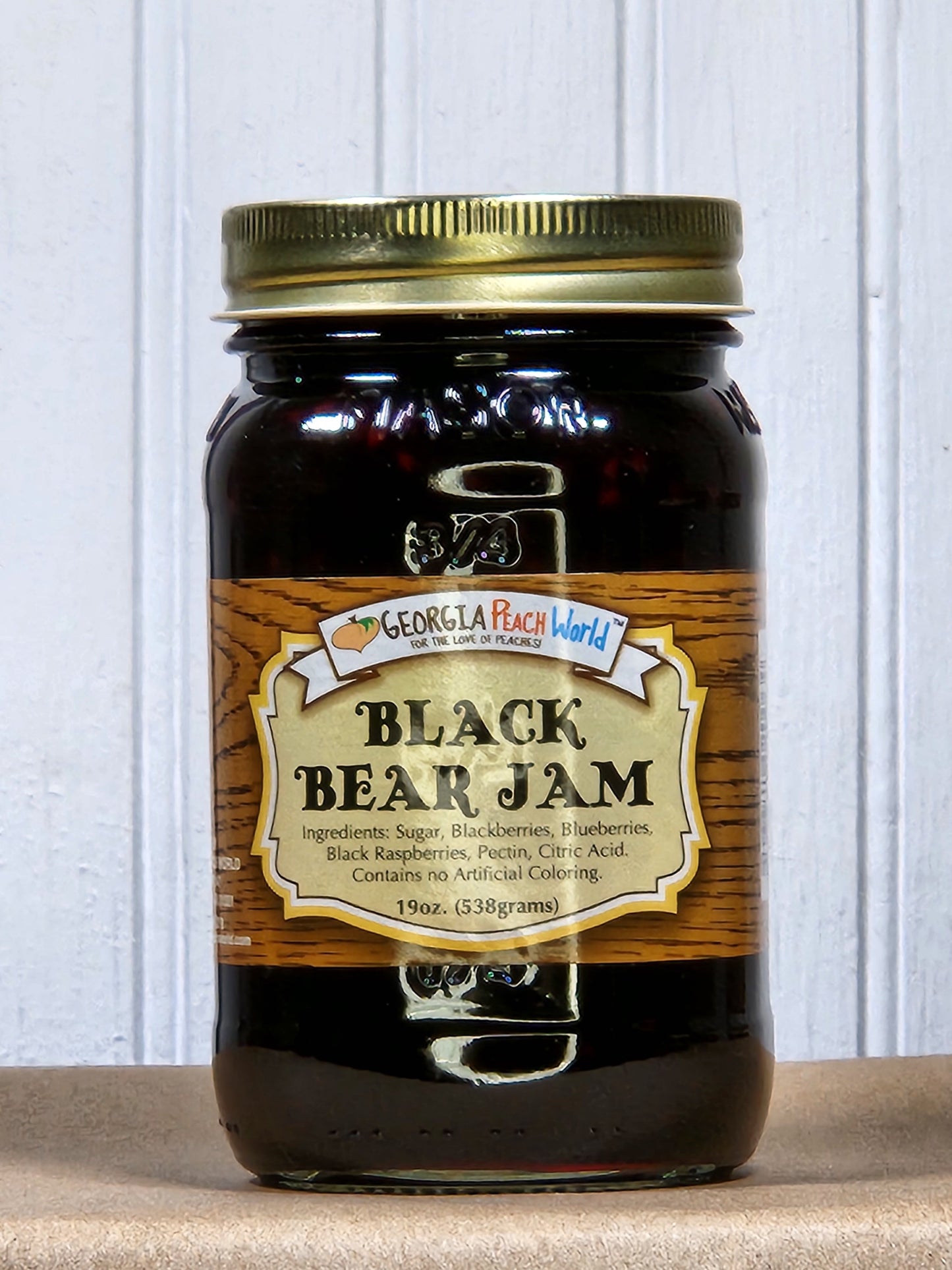 Jar of Black Bear Jam by Georgia Peach World showing the dark, rich jam inside a clear glass jar with a label.