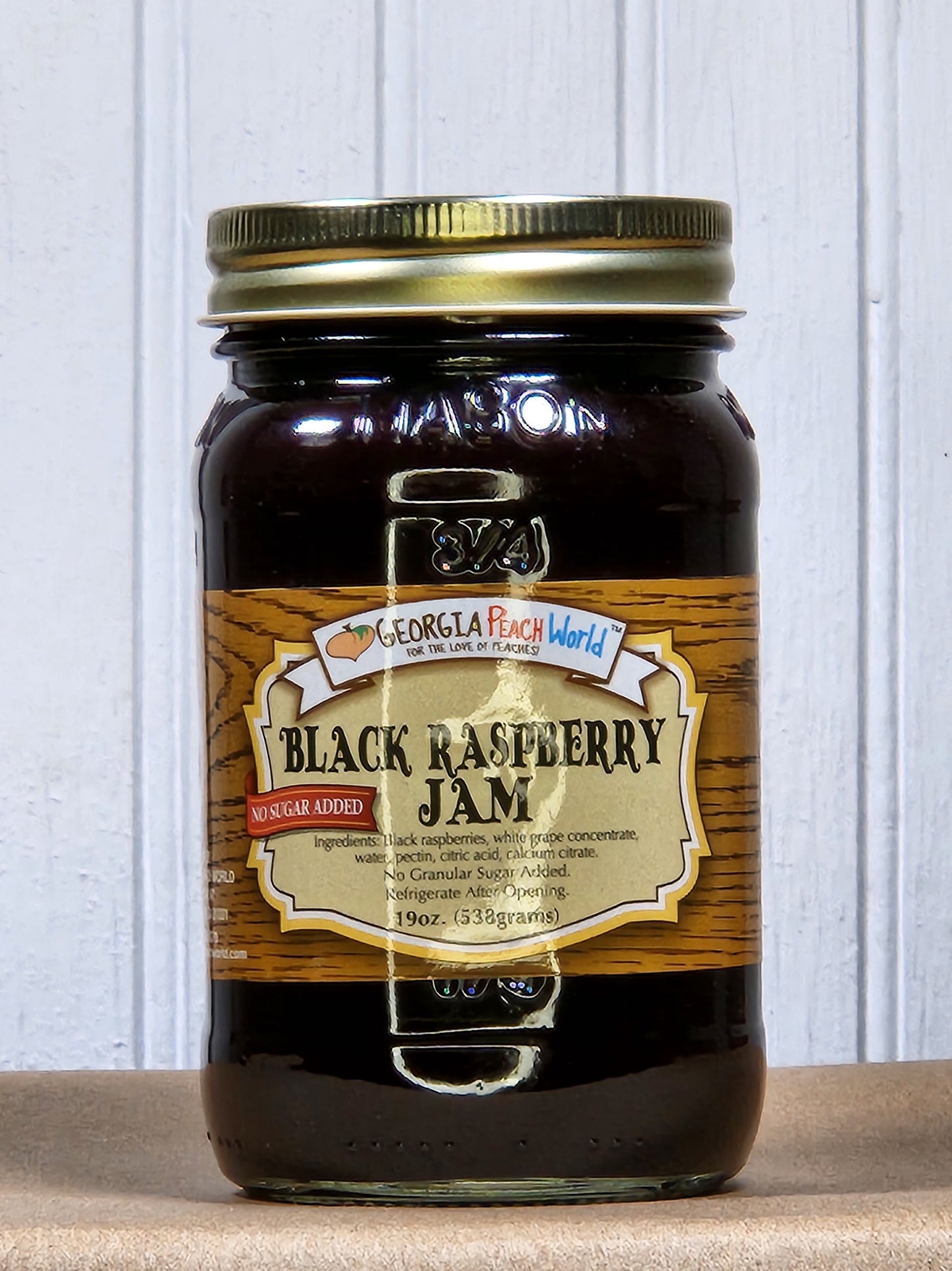 Black Raspberry Jam by Georgia Peach World, no sugar added, shown in a jar with fresh black raspberries and a spread on bread