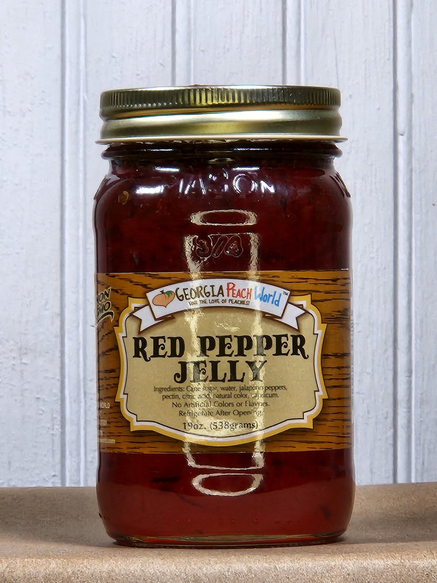 Hot jalapeno pepper jelly jam by Georgia Peach World, showcasing a vibrant, spicy jelly in a clear jar with peppers visible inside.