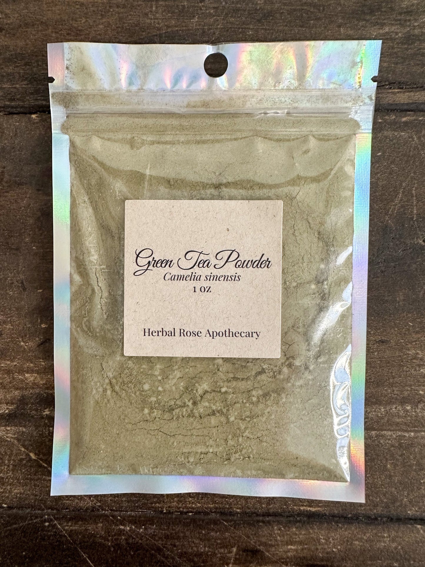 Dried green tea powder in a 1-ounce package from Herbal Rose Apothecary, showcasing vibrant green herbal powder.