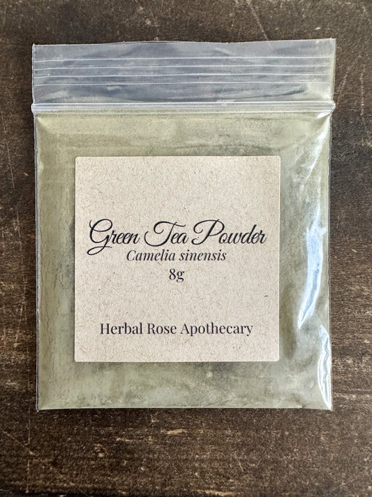 Dried green tea powder in an 8g package by HerbalRoseApothecary, showing vibrant green powdered herbal tea.
