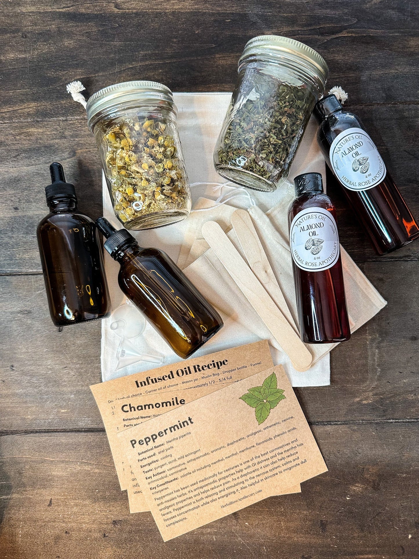 HerbalRoseApothecary DIY Herbal Infused Oil Kit in a box, with herbs, bottles, and instructions for making herbal infused oils.