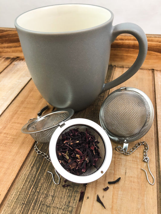 Dried hibiscus herbs from HerbalRoseApothecary showing vibrant red dried flowers and leaves in a natural setting.