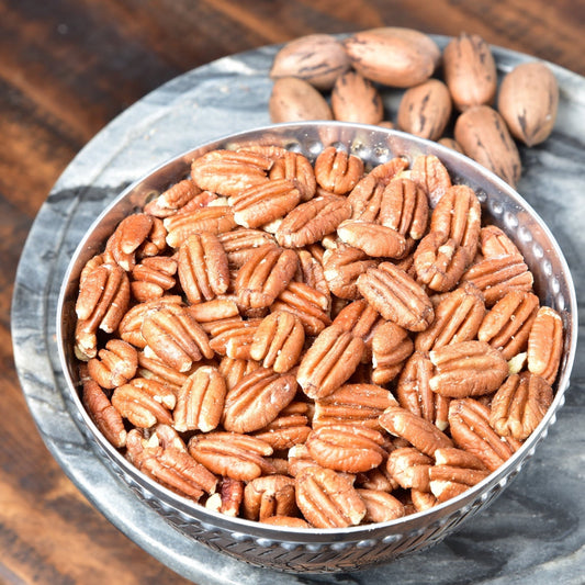 Roasted and salted pecans from Horne Pecan Company in an 8 oz package, showing shiny, golden-brown pecans ready to eat.