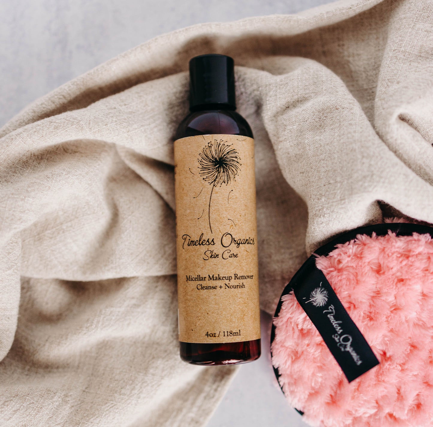 Timeless Organics Skin Care Micellar Cleansing Water removing makeup from a woman's face in a bright setting.