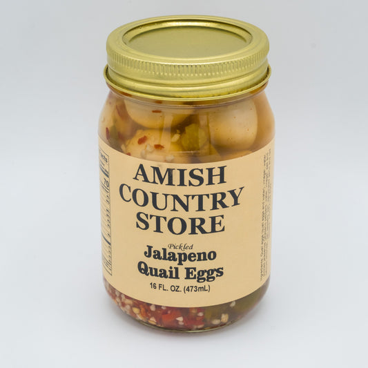 Canned Pickled Jalapeño Quail Eggs from Amish Country Store, showing jar with bright green jalapeños and small quail eggs inside.