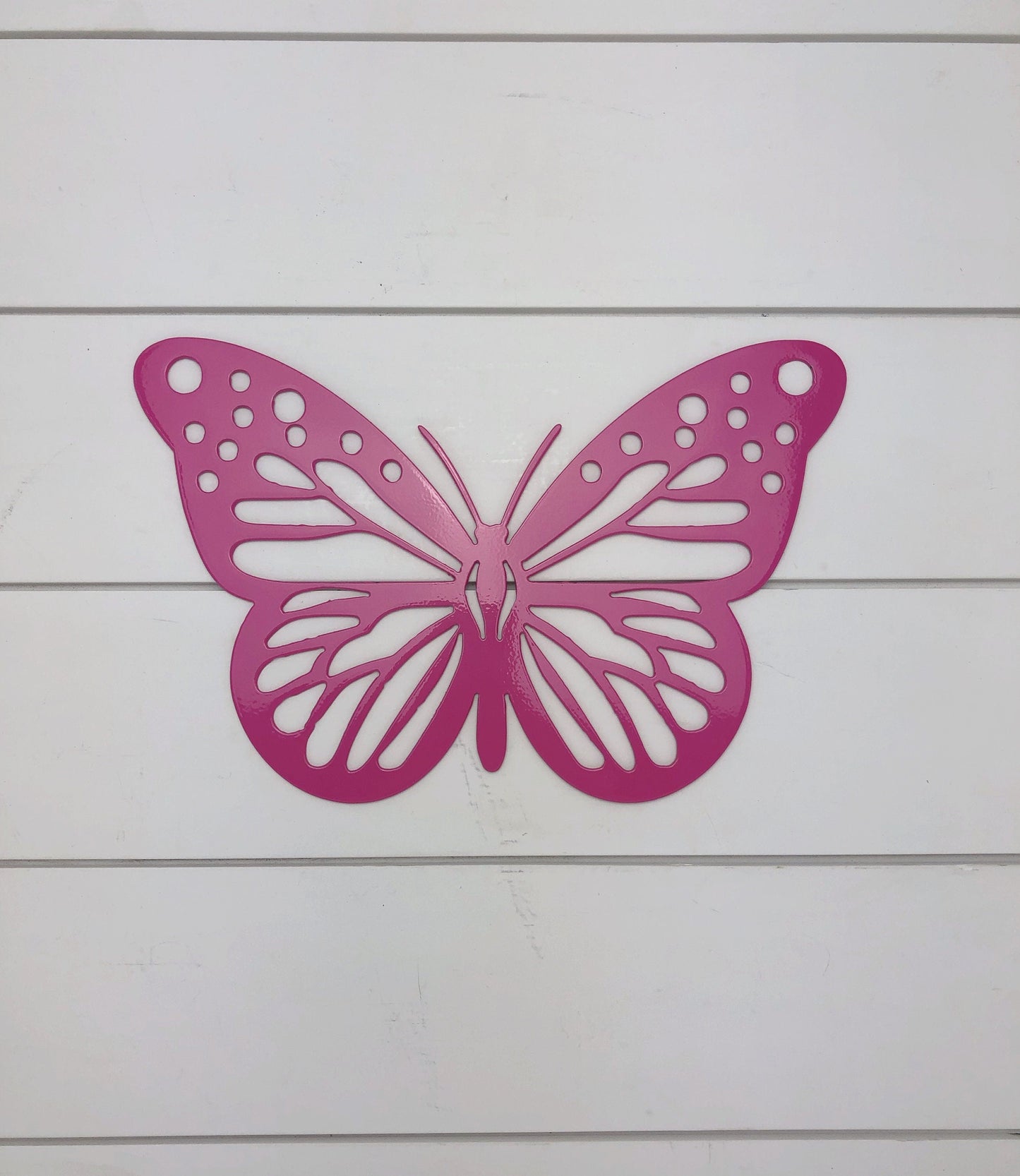 Black metal butterfly sign from Lewis Design Company, outdoor garden decor with butterfly motifs, ideal for patio and garden decoration.