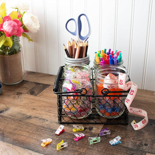 Chicken wire caddy by Mason Jar Lifestyle holding four pint mason jars, perfect for storage or display.