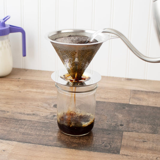 Stainless steel pour-over drip coffee filter for Mason jars, Mason Jar Lifestyle brand, shown resting on a glass Mason jar.