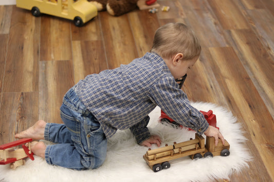 Amish-made wooden log semi-truck toy with removable logs, crafted for children, part of wooden trains and trucks collection.