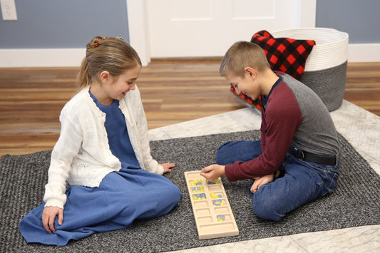 Amish-made solid oak wood Mancala game set with marbles, featuring a crafted wooden board and colorful game marbles.