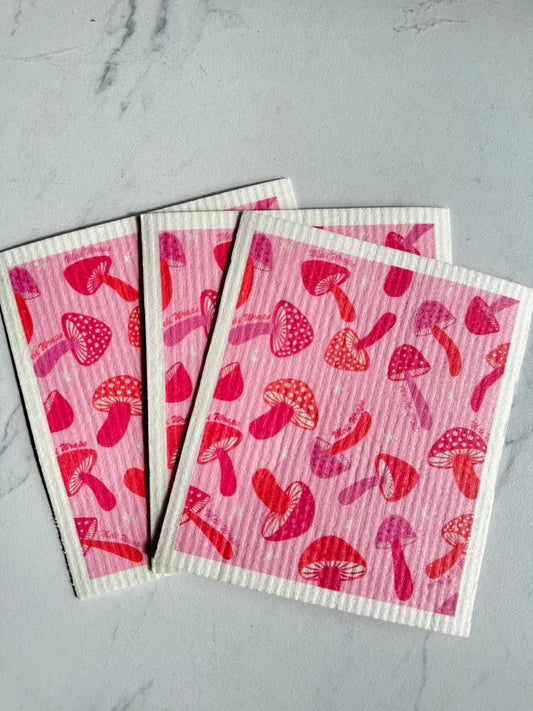 Set of three pink mushroom Swedish dish cloths by Meli Wraps, colorful reusable kitchen cleaning cloths with mushroom design.