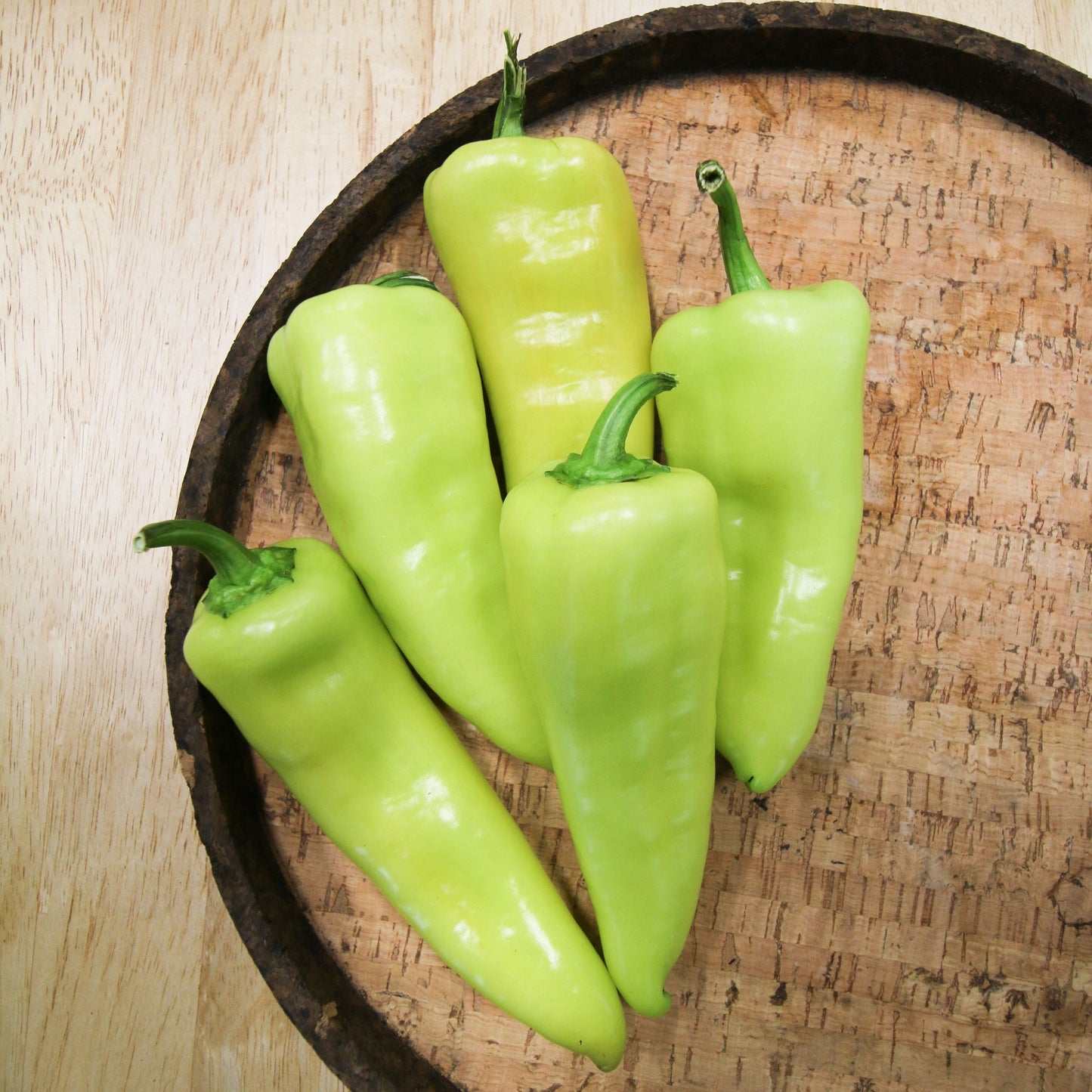 Hungarian Yellow Wax Hot Pepper from MIgardener, bright yellow, elongated pepper with a smooth skin and pointed tip.