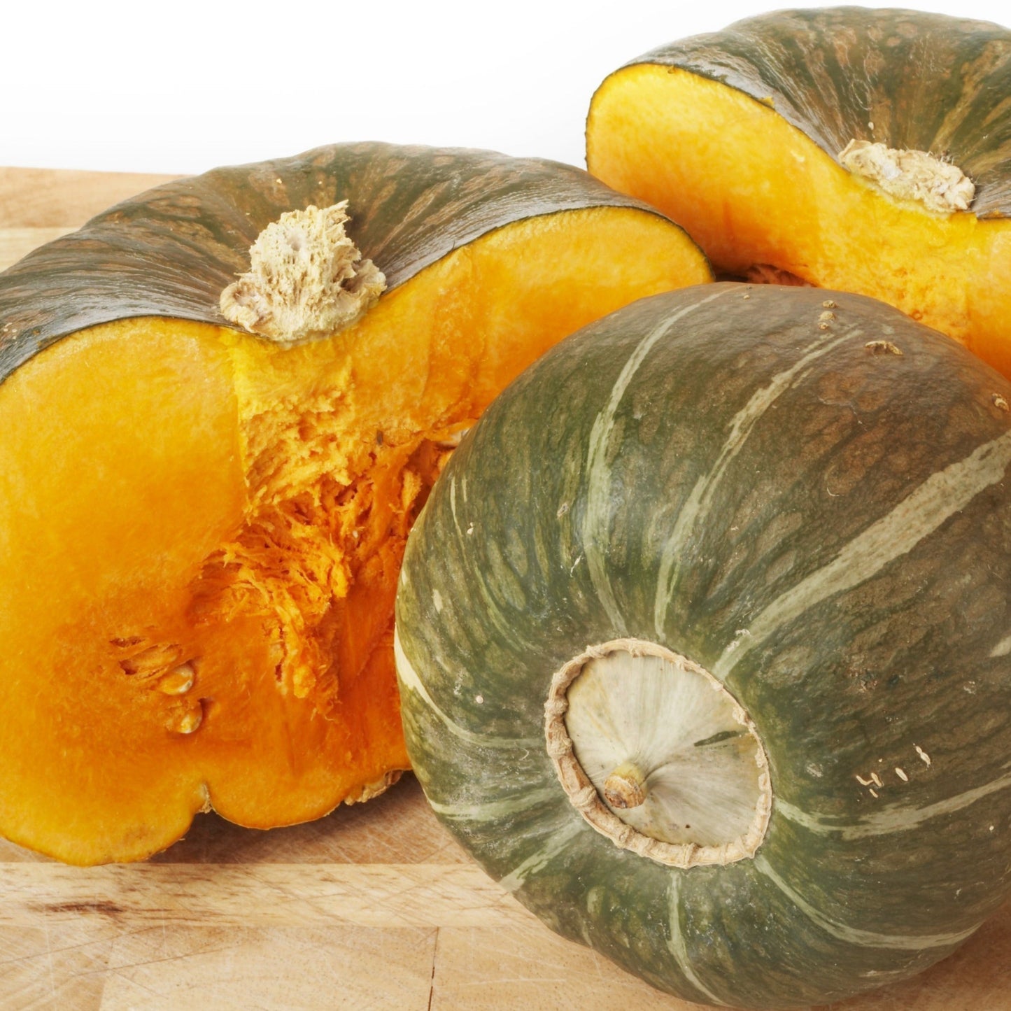 Burgess Buttercup squash from MIgardener, showcasing the vibrant orange and green exterior of the squash in a natural setting.