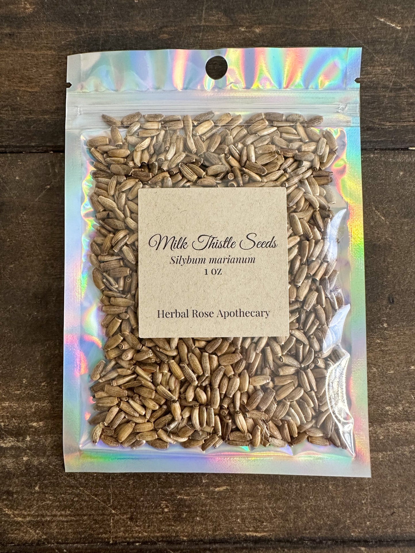 Dried Milk Thistle Seeds in a 1oz package from HerbalRoseApothecary, showing small, dark seeds used for herbal remedies.