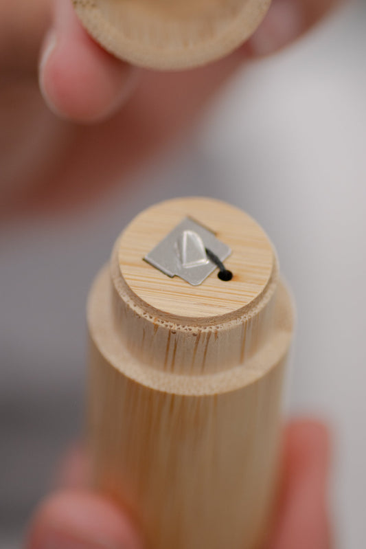 Charcoal dental floss with bamboo holder from NO TOX LIFE, eco-friendly bamboo container for sustainable oral hygiene.