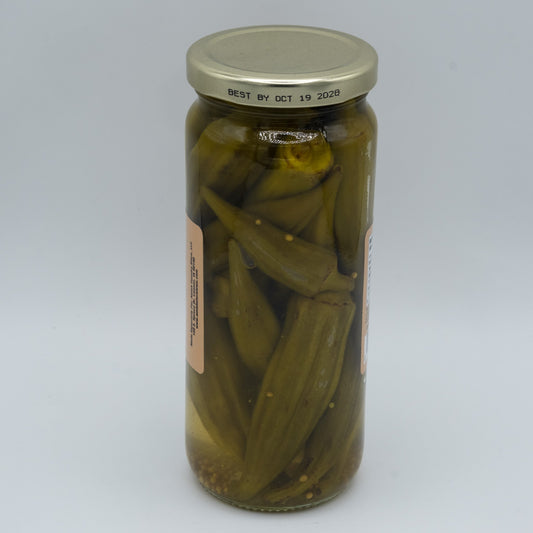 Jar of Amish Country Store Pickled Mild Okra in a clear glass jar with visible green okra spears inside.