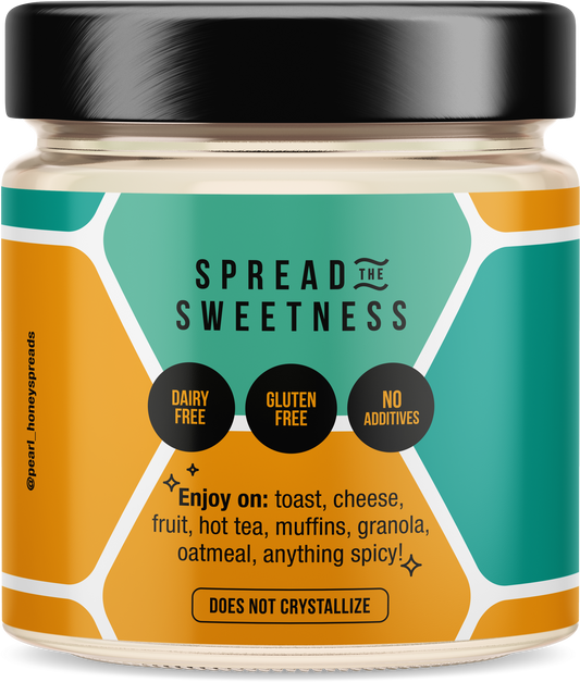Creamed honey from Pearl Honey Spreads in a jar with a smooth, creamy texture and golden color, ready to spread on bread or toast.