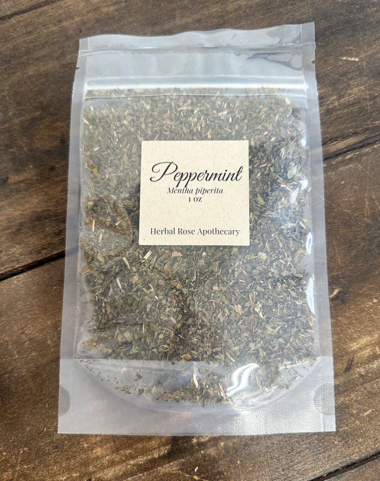 Dried peppermint herbs in a 1oz package from Herbal Rose Apothecary, showing fresh green peppermint leaves and dried herb texture.