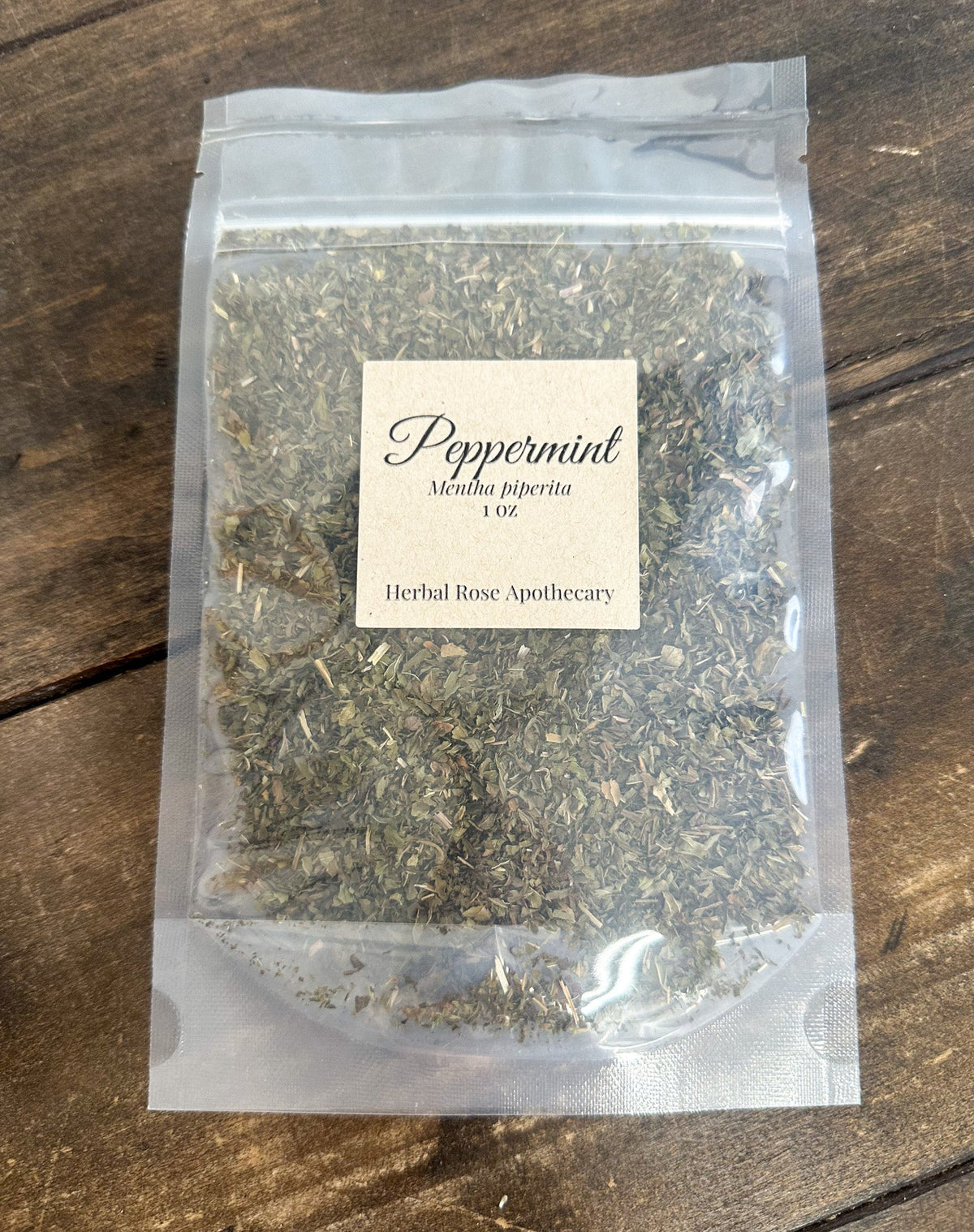 Dried peppermint herbs in a 1oz package from HerbalRoseApothecary, showcasing fresh green peppermint leaves.