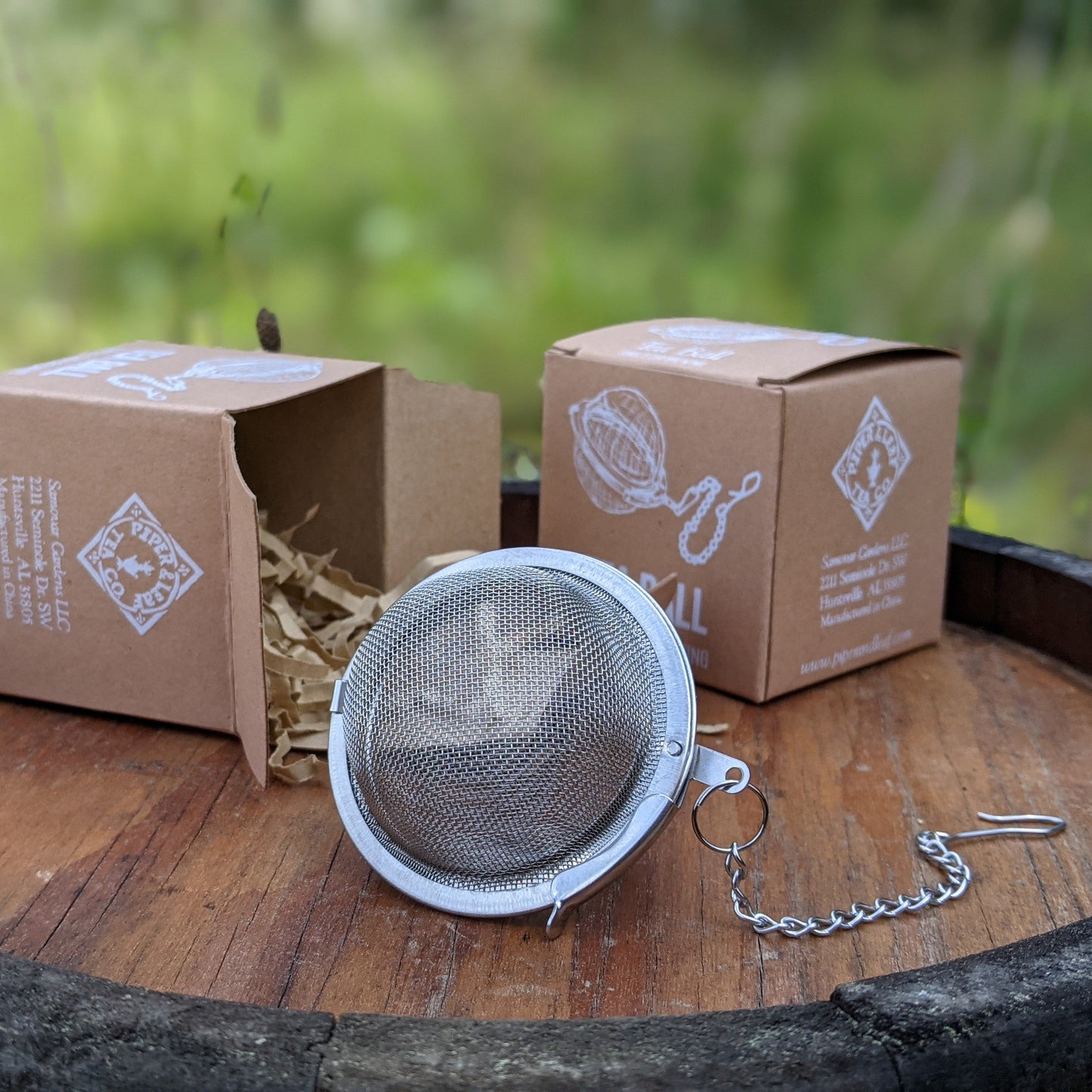 Extra-large Piper Tea Ball from Piper and Leaf Tea Co. shown filled with loose tea leaves, ready for brewing.