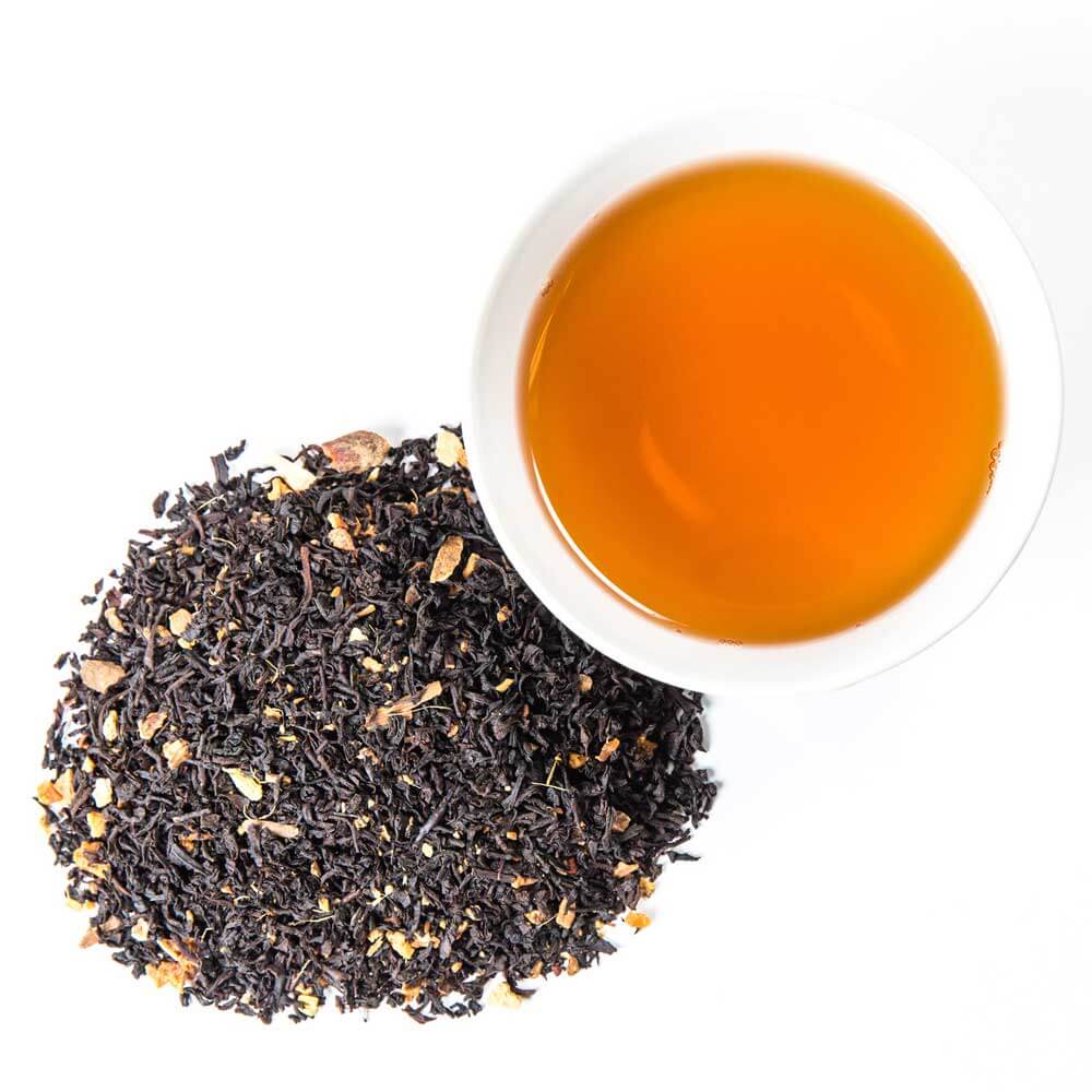 Piper and Leaf Tea Co. caramel apple pie loose leaf tea in a glass jar, showcasing dried tea leaves and apple pieces.